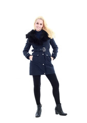 full length portrait of blonde woman wearing long winter coat. and casual clothes. standing pose, isolated on a white studio background.