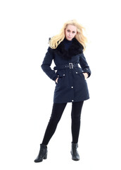full length portrait of blonde woman wearing long winter coat. and casual clothes. standing pose, isolated on a white studio background.