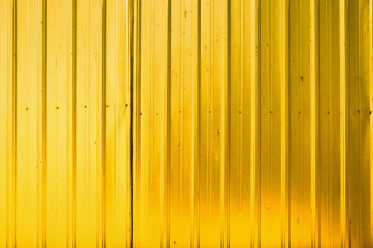 Yellow store front metal iron curtain texture background. Roll up metal blinds background.