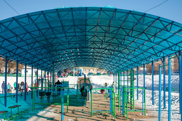 Canopy over sports equipment. Outdoor sports. Sunny winter day. Sports ground in winter.