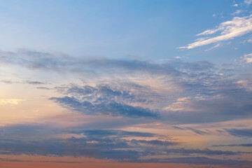 Sunset orange-blue sky with clouds, blur focus.
