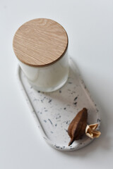  handmade natural soy or coconut candles in glass cups on a concrete stand. crackling wick. natural