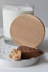 candle in glass and dried flowers