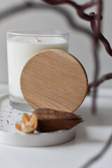 candle in glass and dried flowers