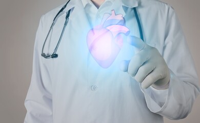 Young doctor touchstone virtual Heart in hand. Healthcare hospital service concept