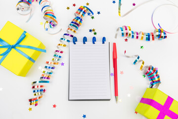 Festive decorations and notebook with wish list on white background , flat lay . Planning concept. - Image