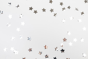 star silver confetti on white background flat lay text place .
