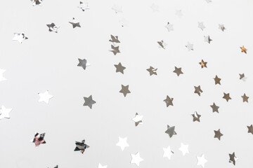 Fototapeta na wymiar star silver confetti on white background flat lay text place .