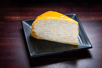 Mille crepe French cake on plate over wooden background, Japanese style