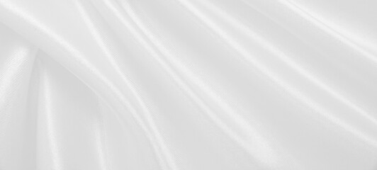 Obraz premium Smooth elegant white silk or satin luxury cloth texture as wedding background. Luxurious background design