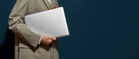 Partial of middle aged businesswoman hold laptop