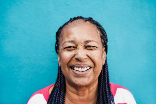 Senior african woman smiling on camera outdoor - Focus on face