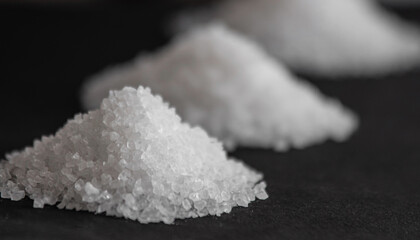White coarse sea salt on a black background