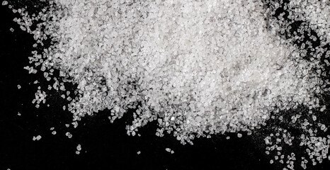 White coarse sea salt on a black background