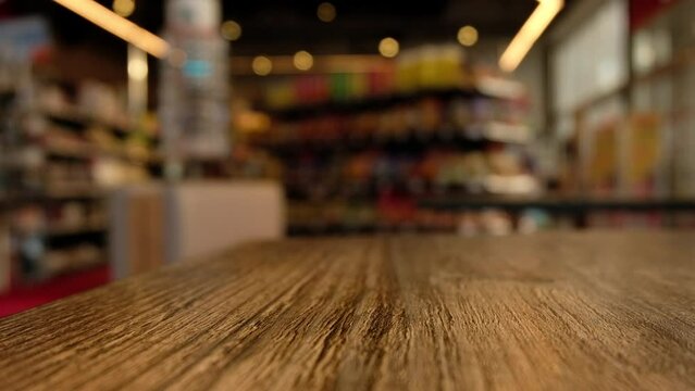 Blurry shopping mall. Wooden table in the cafe