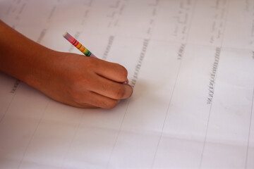 person writing on a paper