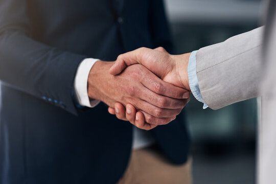 It All Boils Down To Trust. Cropped Shot Of Two Businessmen Shaking Hands In A Modern Office.