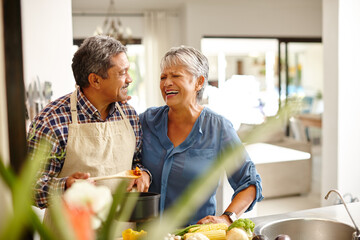 Putting a lot of love into their meal. Shot of a happy senior couple cooking a healthy meal...