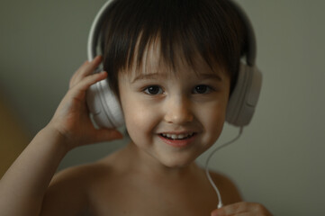 Fototapeta premium the boy listens to music with headphones