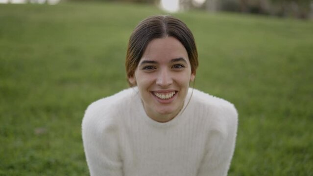 Close view of young brunette smiling and making sad expression