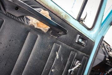 Door panel of an old truck with defect close-up