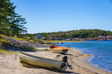 Two boats lie ashore on the North shore of Southkoster Island (Sydkoster) and beautiful view of the...