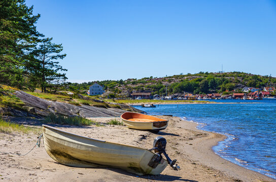 Two boats lie ashore on the North shore of Southkoster Island (Sydkoster) and beautiful view of the North Koster Island (Nordkoster), Bohusl&auml;n, V&auml;stra G&ouml;talands l&auml;n, Sweden.