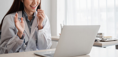 Asian woman doctor is online visiting with a patient on the internet application and Listening of...