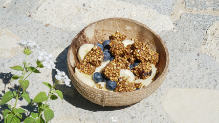 Buckwheat cereal with blueberries and bananas in a coconut bowl