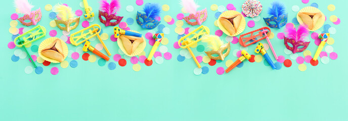 Purim celebration concept (jewish carnival holiday) over blue background. Top view, flat lay