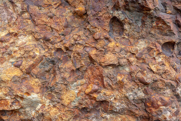 Background texture of natural wall made of brown stones. Horizontal.
