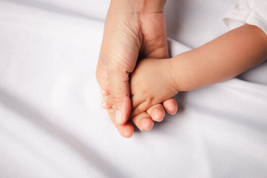 Closeup of mother and child hands with copy space