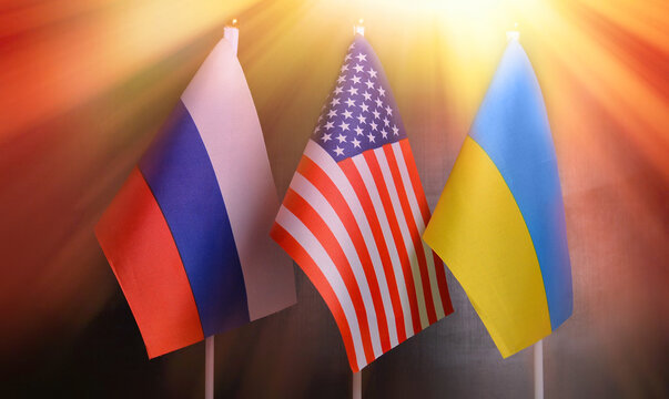 Flags of the USA, Russia, Ukraine on the background of the sun's rays.Concept political conflicts between nations. Peace concept
