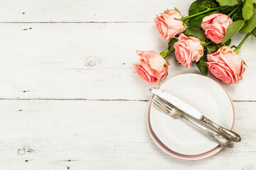 Romantic dinner table on white wooden background. Love concept for Valentine's or Mother's day