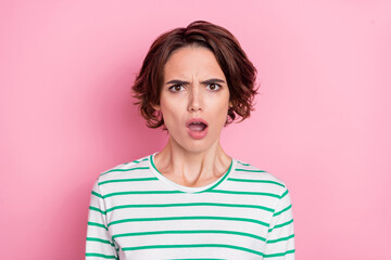 Portrait of attractive worried brunette girl sudden bad news reaction isolated over pink pastel color background