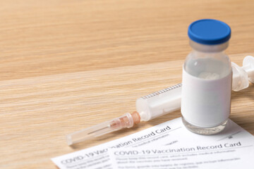 Syringe and vaccine vial for corona virus are on medical form required for travel and tourism. - Image