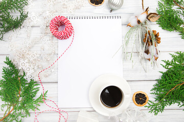 Blank open notepad, pine branches and Christmas decorations on a white wooden table. Space for text. Top view. Flat lay style...- Image