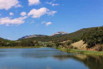 Naklejka na ściany i meble Beautiful lake in the Crimean mountains among greenery and flowers