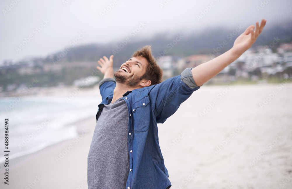 Sticker Aint life grand. Shot of a carefree young man throwing his arms back in joy.