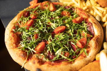 Crudo arugula pizza served in a restaurant