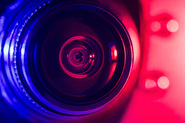 Camera lens with purple and red backlight. Optics. Cyberpunk style