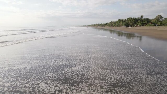 The long and empty coastline of Damas Island on Costa Rica's pacific west coast. Low flying wide angle dolly in