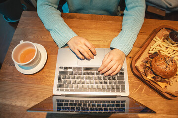 Fototapeta na wymiar overhead view hands type on keyboard wooden table