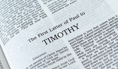 Timothy first letter open Holy Bible Book close-up. New Testament Scripture. Studying the Word of God Jesus Christ. Christian biblical concept of faith, hope, and trust.
