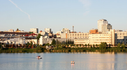 The Lake Nizhny Kaban. Kazan, Tatarstan, Russia: July 14 2021. The embankment of the Lower Kaban Lake. Tourists are walking and boating. Photo with copy space. Panoramic view of the embankment