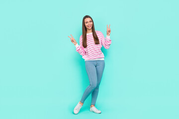 Naklejka premium Full length body size view of attractive cheerful funky girl showing v-sign having fun isolated over bright teal turquoise color background