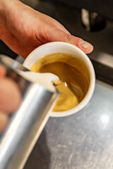 Barista hand making cappuccino Coffee with espresso and milk in cafe