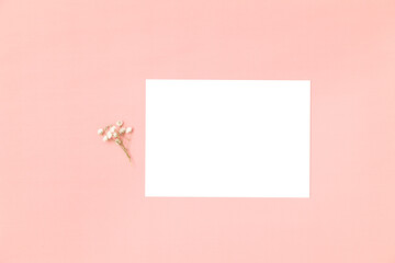 Wedding invitation or greeting card mockup on a pink background.