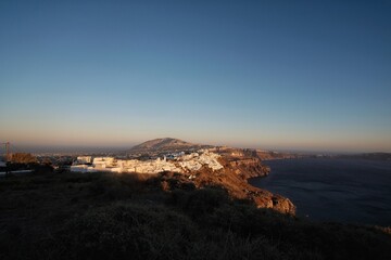 Beautiful big terrace with trees and  a breathtaking view over the volcano and the aegean sea in Santorini Greece