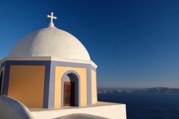 Fototapeta na wymiar View of a colorful orthodox church and a ferry boat in the distance in Santorini Greece